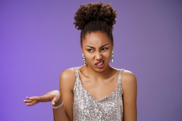 Portrait of young woman against gray background