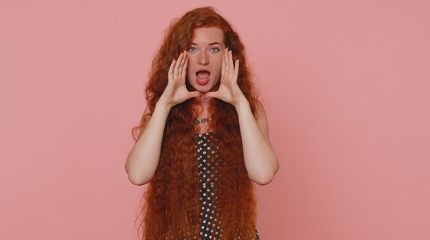 Portrait of young woman against pink background