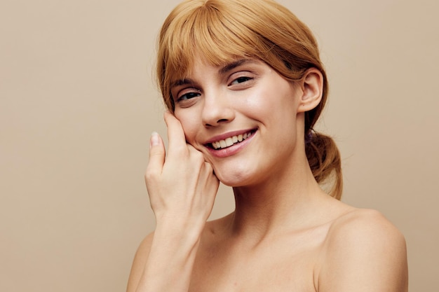 Portrait of young woman against pink background