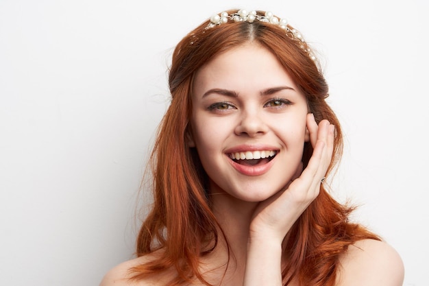 Portrait of young woman against white background