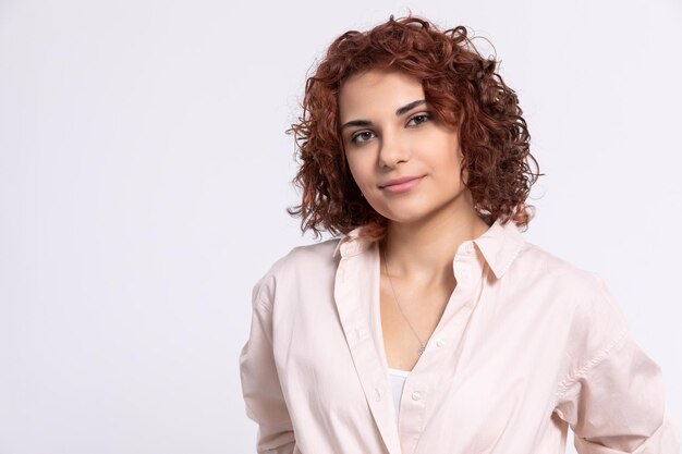 Portrait of young woman against white background