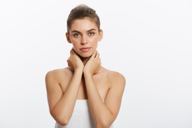 Portrait of young woman against white background