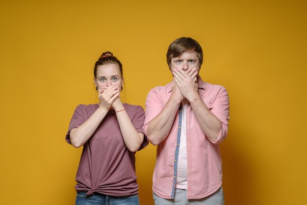 Portrait of young woman against yellow background