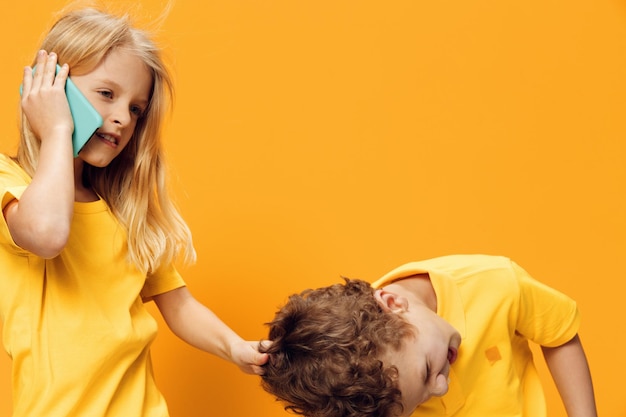 Portrait of young woman against yellow background