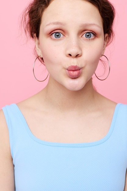 Portrait of young woman against yellow background