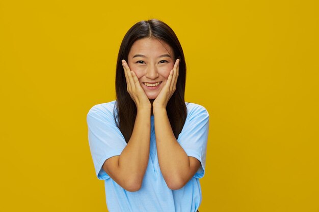 Portrait of young woman against yellow background