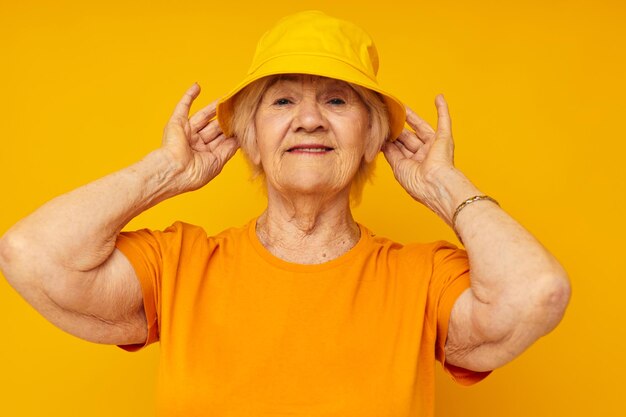 Portrait of young woman against yellow background