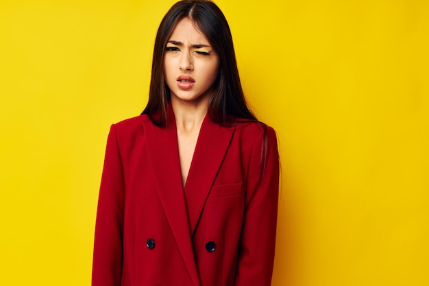 Portrait of young woman against yellow background