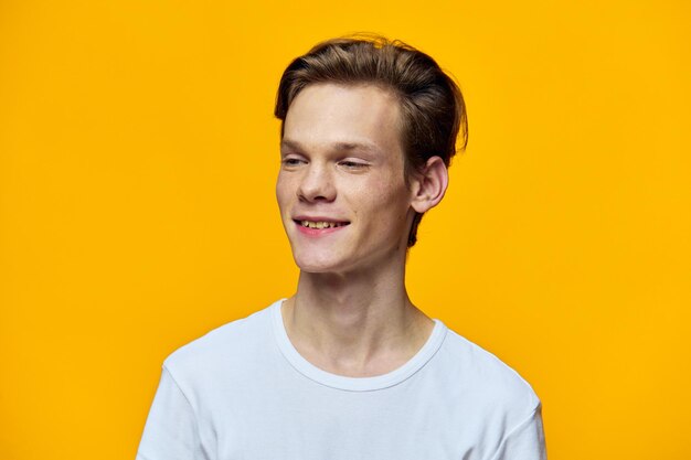 Portrait of young woman against yellow background