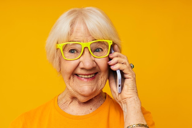 Portrait of young woman against yellow background