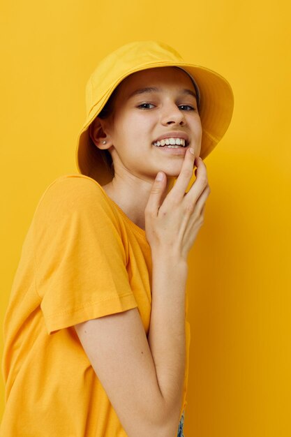 Portrait of young woman against yellow background