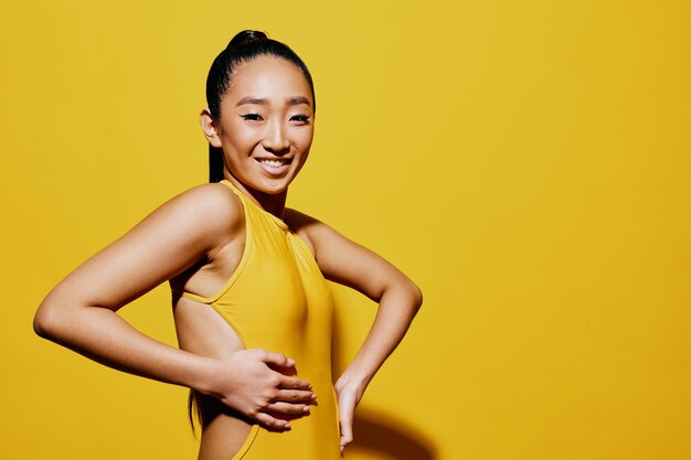 Portrait of young woman against yellow background