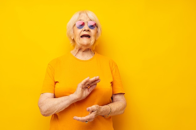 Portrait of young woman against yellow background