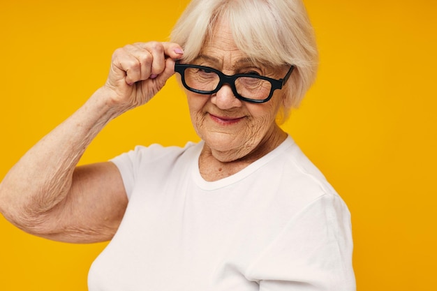 Portrait of young woman against yellow background