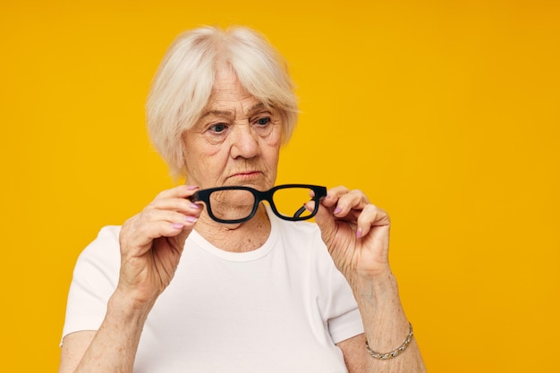 Portrait of young woman against yellow background