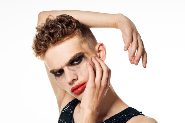 Photo portrait of young woman applying make-up against white background