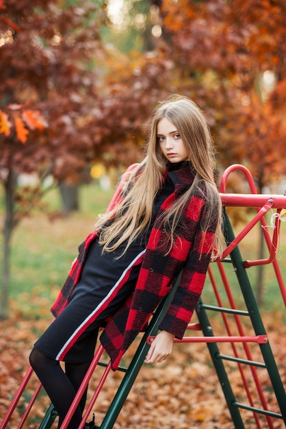 Portrait of young woman in autumn park