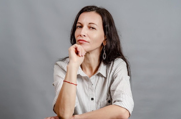 Portrait of young woman backed chin by hand