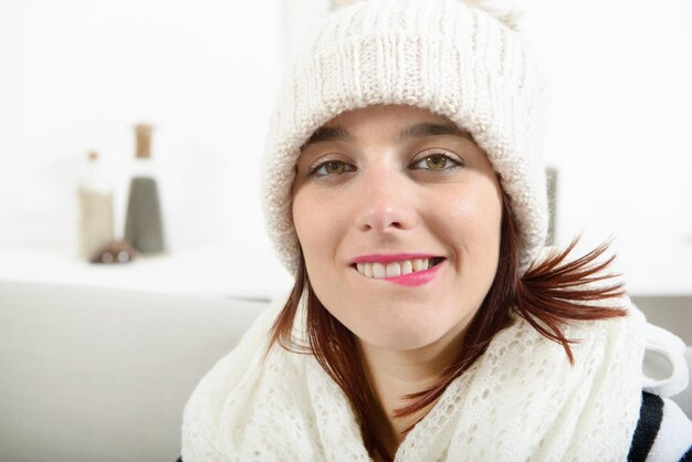 Portrait of young woman biting lips at home