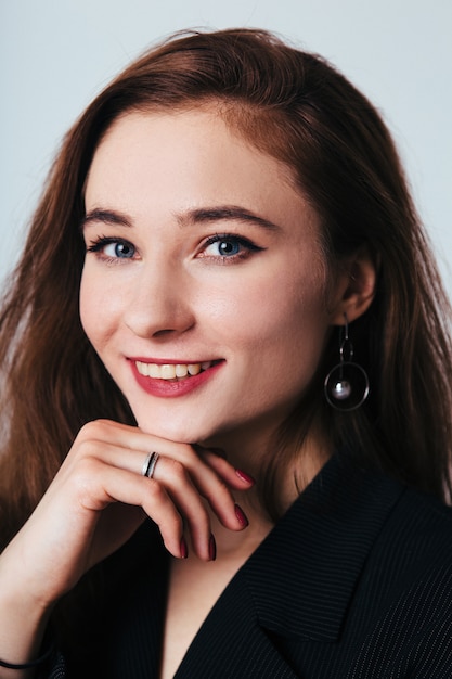 Portrait of young woman in black suit on white background. Girl in black isolated