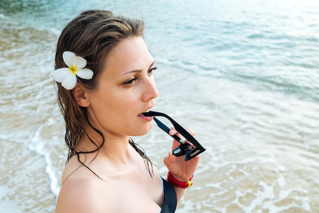 Portrait of young woman in black swimsuit