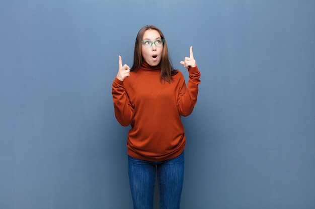 Portrait of a young woman on a blue background