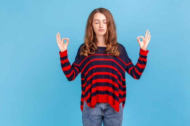 Portrait of young woman on blue background