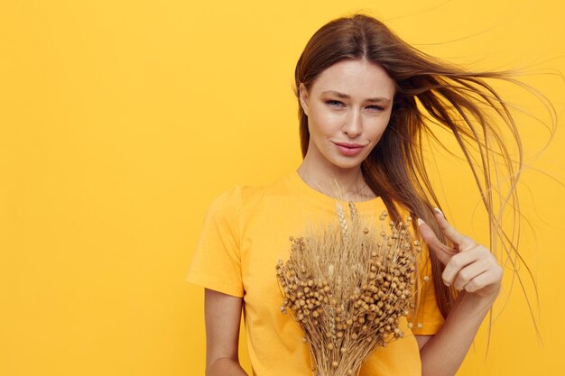 Portrait of a young woman bouquet of dried flowers casual wear smile posing isolated background