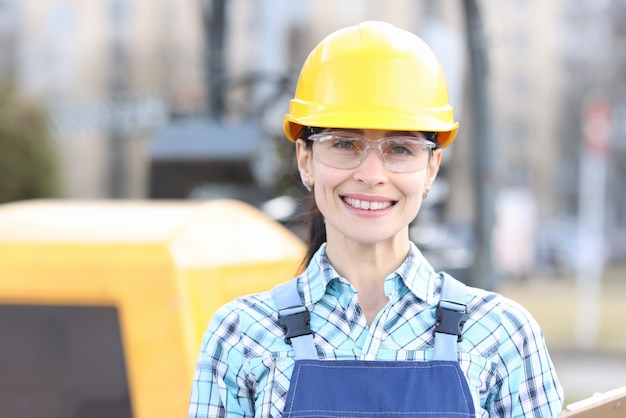 Portrait of young woman builder in hard hat