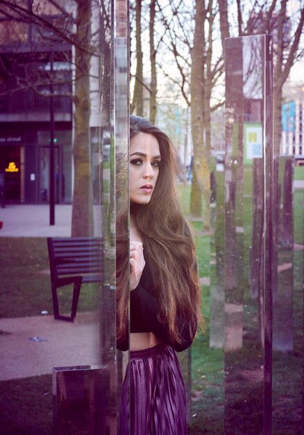 portrait of young woman by mirror sculpture