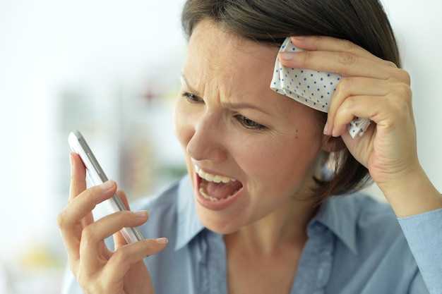 Portrait of young woman calling doctor on the phone