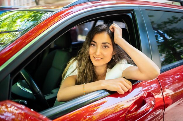 Portrait of young woman in car