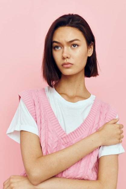 Portrait of a young woman casual wear youth style hand gesture pink background