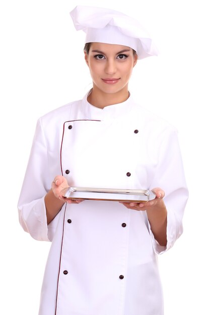 Portrait of young woman chef with tray isolated on white