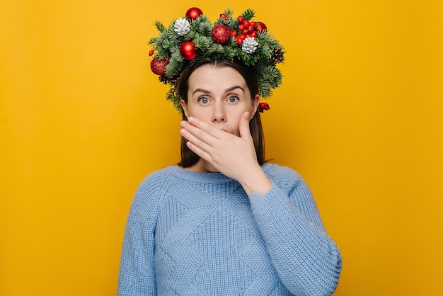 Portrait of young woman in Christmas wreath