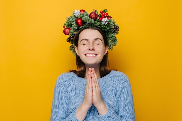 Portrait of young woman in Christmas wreath