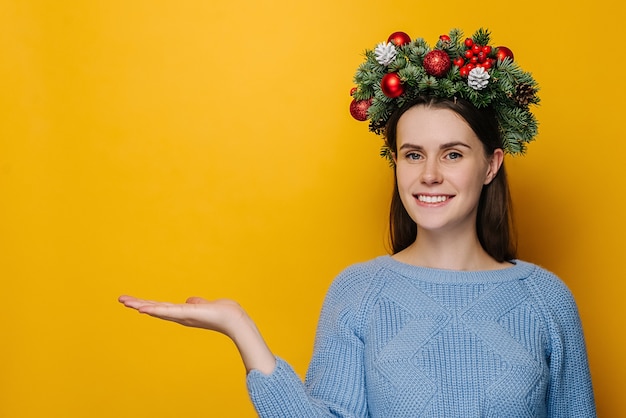 Portrait of young woman in Christmas wreath