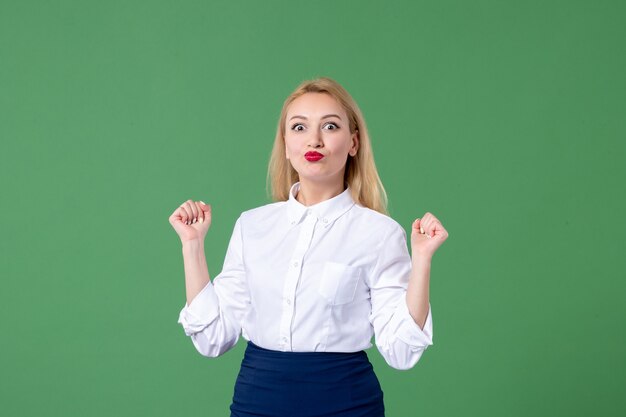 portrait of young woman in conservative clothing green wall lesson teacher school study