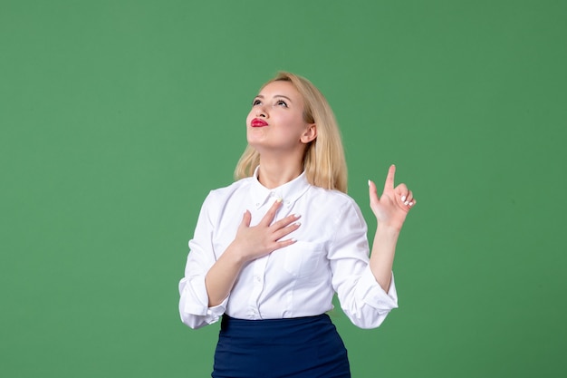 portrait of young woman in conservative clothing green wall teacher lesson school