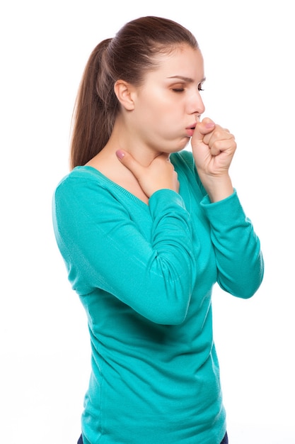 Portrait of an young woman coughing with fist 