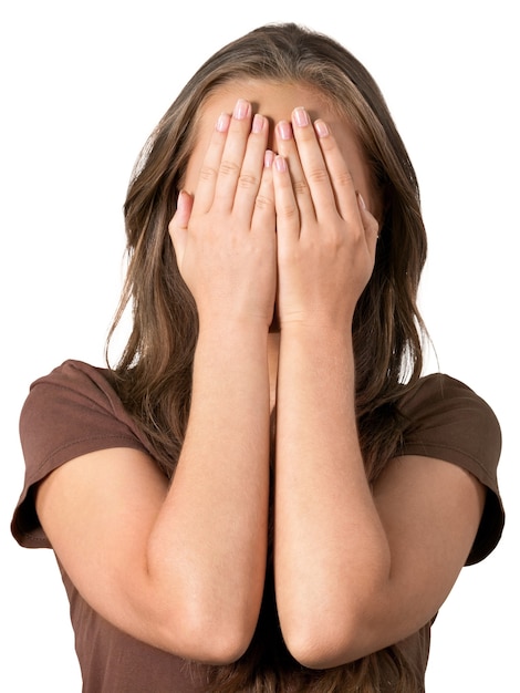 Photo portrait of a young woman covering her face with hands