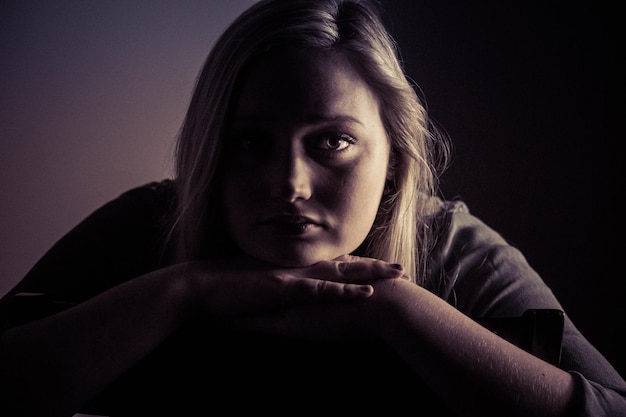 Portrait of young woman in darkroom at home