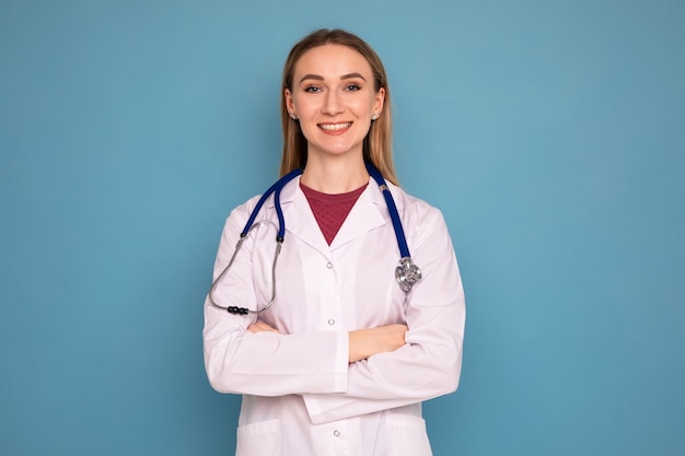 Portrait of a young woman doctor on a blue background