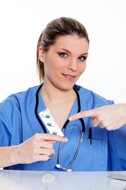 Portrait of young woman doctor with pills