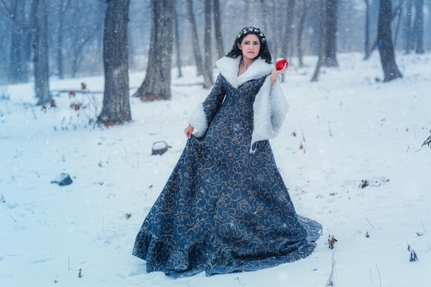 Portrait of young woman dressed in blue coat