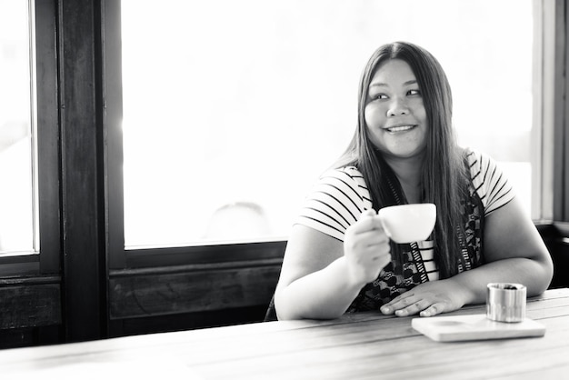 Portrait of young woman drinking coffee