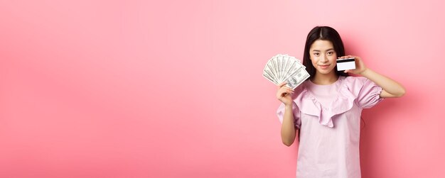 Photo portrait of young woman drinking milk against yellow background