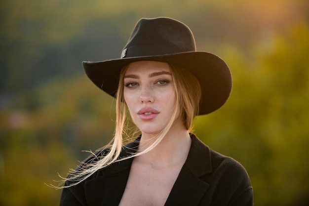 Portrait of a young woman in elegant hat with a wide brim close up face of beautiful woman outdoor c