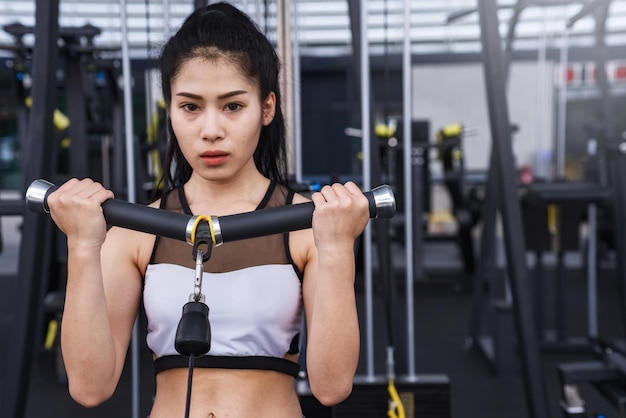 Portrait of young woman exercising in gym