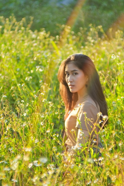 Portrait of young woman on field